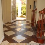 Entryway to a home with ornate tile flooring and a wooden staircase