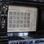 Decorative tile backsplash behind a gas stove