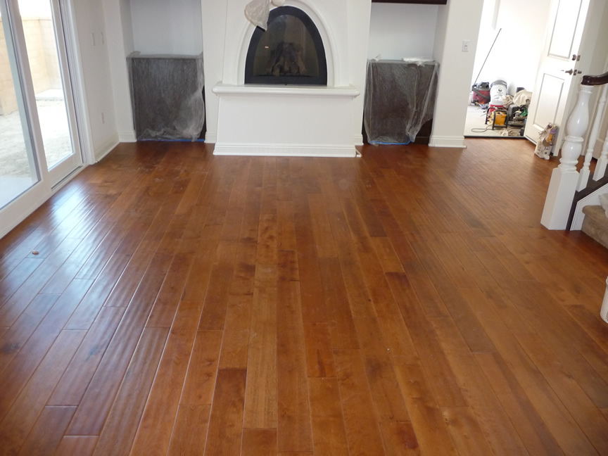 An empty room with white walls and hardwood floors